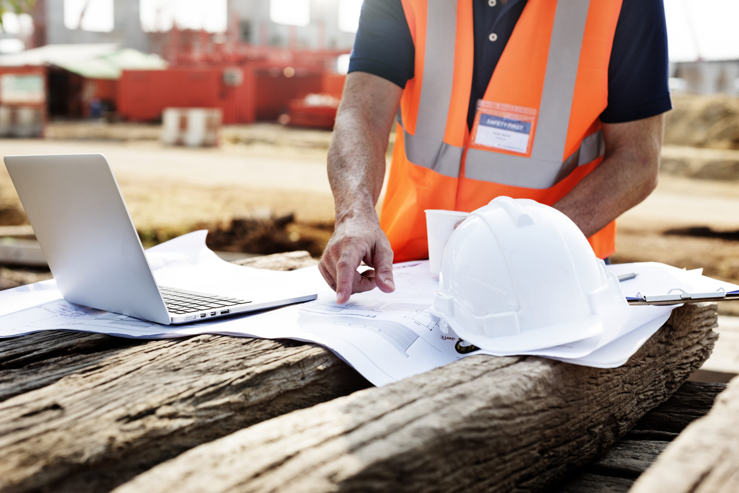 closeup contractor construction site pointing plan wooden sleeper scaled